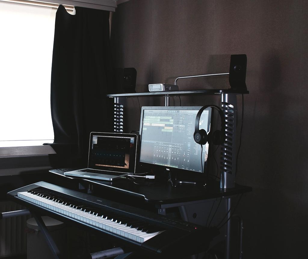 Person typing on laptop with headset